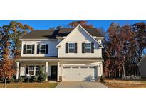 Two-story white house with a two-car garage and landscaping at 5971 Trinity Crossing Cir, Kannapolis, NC 28081