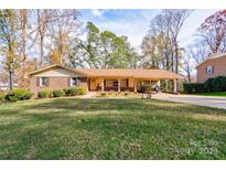 Ranch-style home with brick facade and carport, nicely landscaped yard at 608 Hanover Dr, Shelby, NC 28150