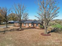 Brick ranch house with a large yard and mature trees at 6515 Deep Springs Rd, Marshville, NC 28103