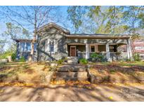 Charming craftsman home with a spacious front porch and mature trees at 600 W Warren St, Shelby, NC 28150