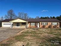 Ranch style home with attached garage and landscaped yard at 7855 Nc Highway 90 E None, Stony Point, NC 28678