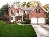 Brick two-story house with a two-car garage and landscaping at 8905 Parkcrest St, Huntersville, NC 28078