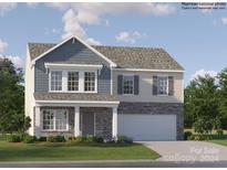 Two-story house with gray and beige siding, stone accents, and a two-car garage at 1165 Blackburn Cir, Edgemoor, SC 29712