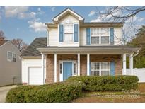 Two-story house with brick and siding, attached garage, and a landscaped front yard at 1351 Hollythorn Dr, Rock Hill, SC 29732