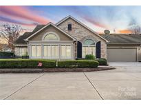 Inviting exterior of charming ranch home with stone accents and landscaped landscaping at 4875 Polo Gate Blvd, Charlotte, NC 28216