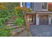 Stone steps leading to a home's entrance, surrounded by lush landscaping at 2014 New Hope Rd, Charlotte, NC 28203