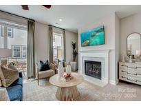 Bright living room features a fireplace and plenty of natural light at 505 Annie Lowery Way, Davidson, NC 28036