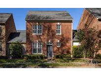 Brick front elevation of charming townhome with landscaped yard at 592 S Main St, Belmont, NC 28054