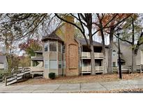 Inviting exterior of charming condo with wood siding and brick accents at 6020 Gray Gate Ln # I, Charlotte, NC 28210