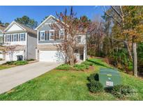 Two-story home with gray siding, stone accents, and a two-car garage at 6076 Artigas Dr, Fort Mill, SC 29707