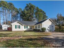 Ranch home with attached garage and landscaped yard at 7909 Lawyers Rd, Charlotte, NC 28227