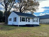 Charming white house with black trim and a well-maintained lawn at 131 Westover Ave, Kannapolis, NC 28081