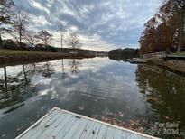 Scenic lakefront property with calm water and tree-lined shores at 4550 Enoch Dr, Sherrills Ford, NC 28673