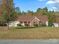 Brick ranch home with attached garage and carport, situated on a spacious lot at 3327 Harmony Rd # 18, Catawba, SC 29704