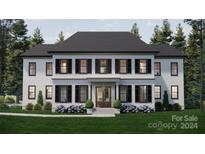 Two-story home with white siding, black shutters, and a dark roof at 0 S Potter Rd # 2A, Waxhaw, NC 28173