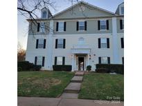 Three-story building exterior with landscaping and walkway at 1174 Plaza Walk Dr, Charlotte, NC 28215