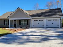 Ranch style home with three-car garage and covered porch at 190 Williamson St, Troy, NC 27371