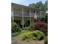 Two-story home with wrap-around porch and landscaped yard at 306 Mcadenville Rd, Lowell, NC 28098