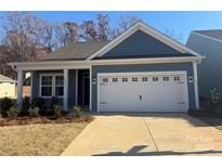 One-story home with gray siding, white garage door, and landscaping at 1058 Bull Dog Ln, Wingate, NC 28174