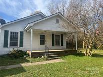 White house with green shutters, front porch, and small yard at 707 7Th St, Spencer, NC 28159