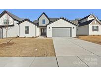 Modern two-story home with gray garage door and white brick exterior at 148 Windy Dell Dr, Tega Cay, SC 29708