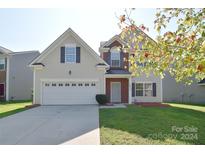 Two-story house with a neutral color scheme, a large garage, and a well-maintained lawn at 9316 Macquarie Ln, Charlotte, NC 28227