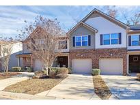 Brick front exterior of townhome with attached garage and landscaping at 5021 Mockernut Ln, Fort Mill, SC 29707