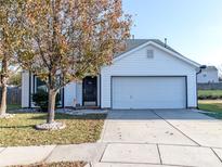 White house with a black door, two-car garage, and landscaping at 7707 Konsler Dr, Charlotte, NC 28214