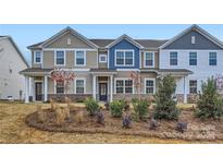 Two-story townhome with neutral siding and landscaping at 9732 Inkberry Dr, Gastonia, NC 28056