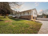Ranch style home with front porch and landscaped yard at 104 Vista Dr, Davidson, NC 28036