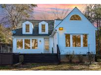 White house with deck, hot tub, and lake view at 228 Sugar Loaf Dr, Troy, NC 27371