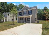 Two-story house with gray siding, a driveway, and landscaping at 6316 Linda Vista Ln, Charlotte, NC 28216