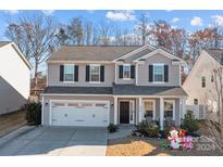 Two-story house with gray siding, white trim, and a two-car garage at 6230 Durango Way, Denver, NC 28037