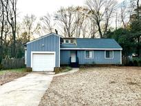 Ranch style home with attached garage and mature trees at 6719 Paloverde Ln, Charlotte, NC 28227