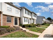 Front view of charming townhome with brick and siding at 9432 Lexington Cir # E, Charlotte, NC 28213