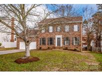 Two-story brick home with gray shutters and a well-manicured lawn at 316 Reed Creek Rd, Mooresville, NC 28117