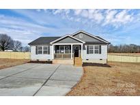 Newly constructed home with gray siding, a covered porch, and a concrete driveway at 882 Old Mocksville Rd # 2, Statesville, NC 28625