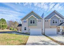 Two-story townhouses with attached garages and a landscaped yard at 208 Pawley Dr, Charlotte, NC 28214