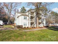 Exterior view of a two-story condo building with trees and landscaping at 1032 Churchill Downs Ct, Charlotte, NC 28211