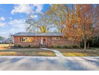 Brick ranch house with landscaped yard and walkway at 5001 Currituck Dr, Charlotte, NC 28210