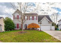Two-story house with gray siding, burgundy shutters, and a well-manicured lawn at 6071 Underwood Ave, Charlotte, NC 28213