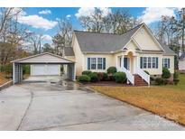 Charming yellow house with a carport and landscaped yard at 2429 Prince Dr, Lancaster, SC 29720