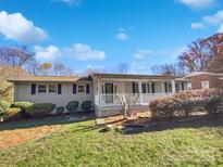Ranch style home with front porch, landscaping, and a brick facade at 104 Abingdon Cir, Huntersville, NC 28078