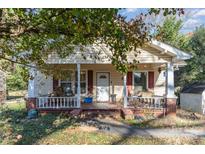 Charming 1-story house with a porch and well-maintained lawn at 307 E 2Nd St, Lowell, NC 28098