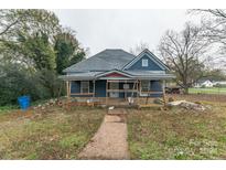Blue house undergoing renovation with scaffolding and landscaping at 1119 Poplar St, Albemarle, NC 28001