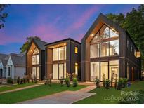 Modern three-unit building with dark exterior and large windows at 4026 Chevington Rd # 101, Charlotte, NC 28226
