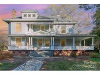 Charming two-story home with a welcoming front porch and landscaped yard at 318 N Elm St, Marshville, NC 28103
