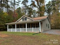 Charming one-story house with a front porch and landscaped yard at 369 Pinecrest Cir, Troy, NC 27371