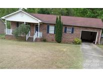 Brick ranch house with attached garage and front porch at 5487 Twelve Oak Ln, Conover, NC 28613