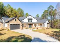 Stunning two-story home with stone accents and a large driveway at 5164 Green Rd, Stanley, NC 28164